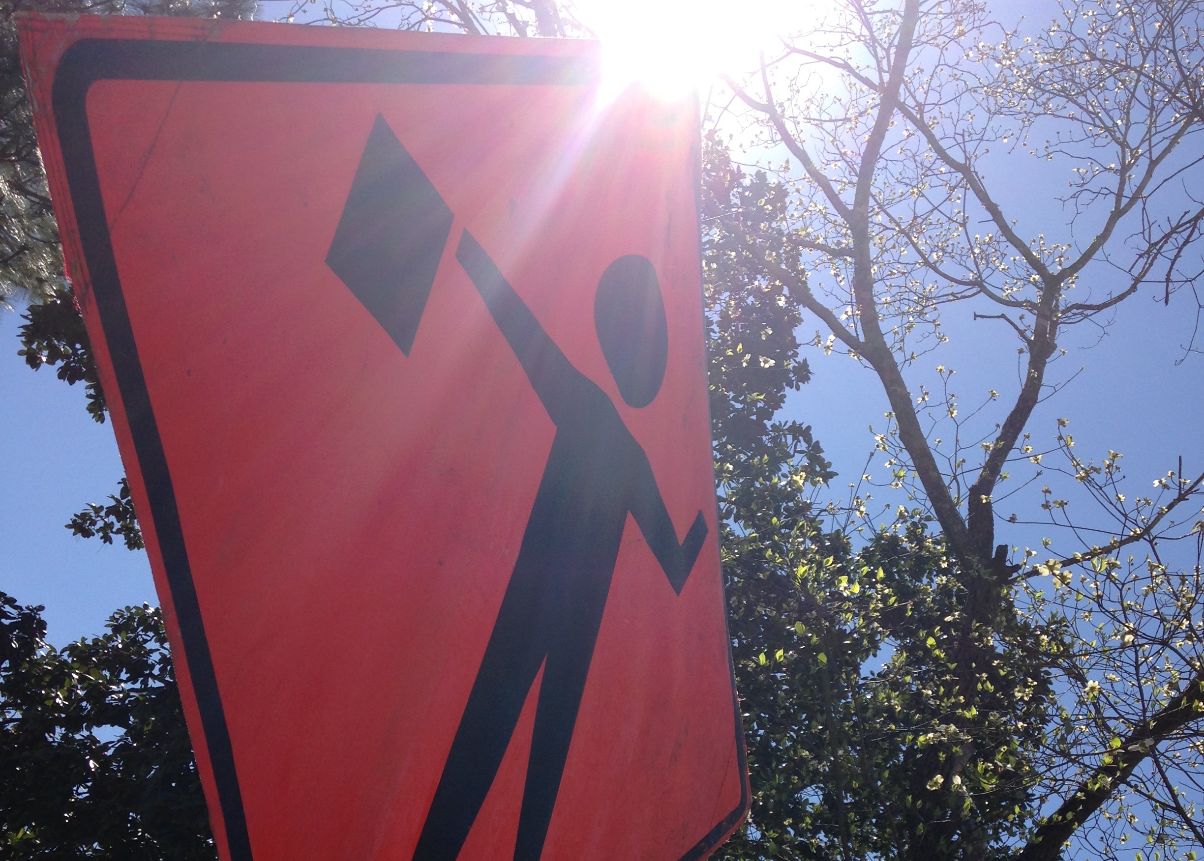 road sign with sun in background